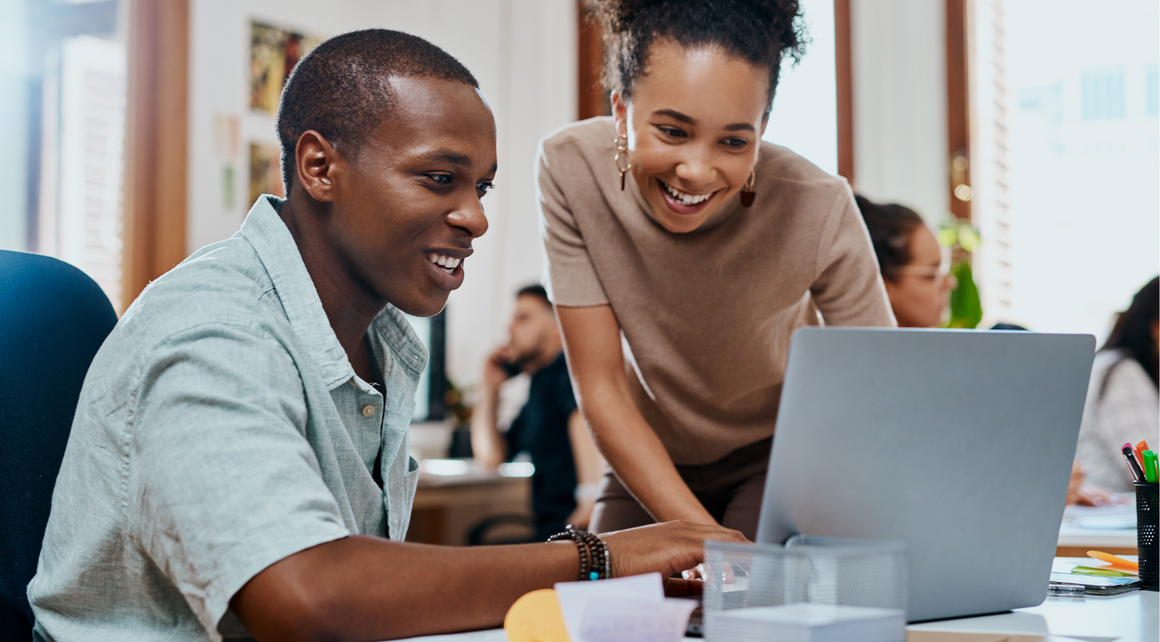 Photo of two individuals working together